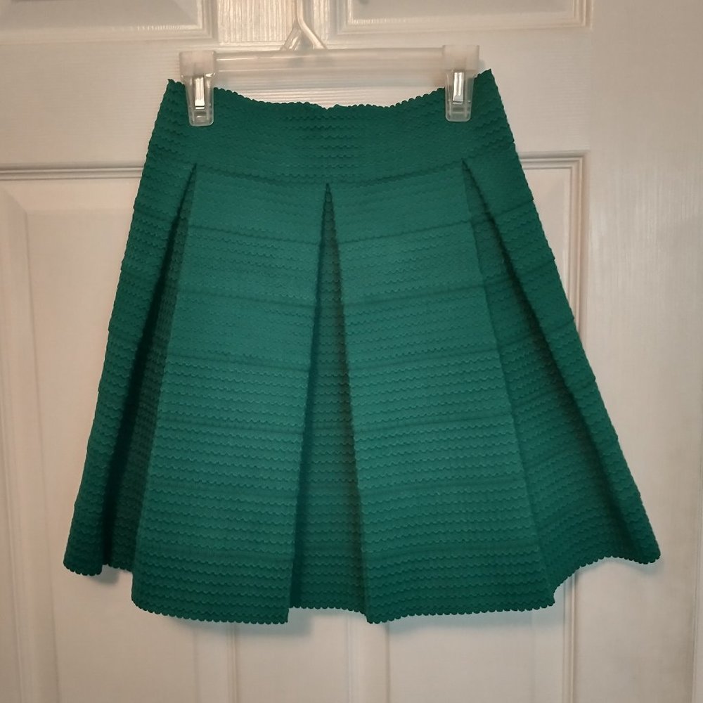 Pleated, emerald green mini skirt
